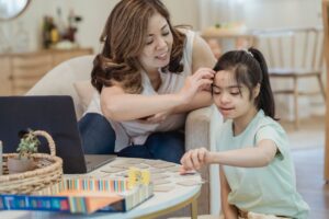Little girl and her mother playing a game